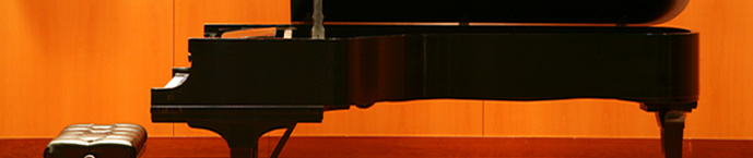 A photograph of a piano and a piano bench